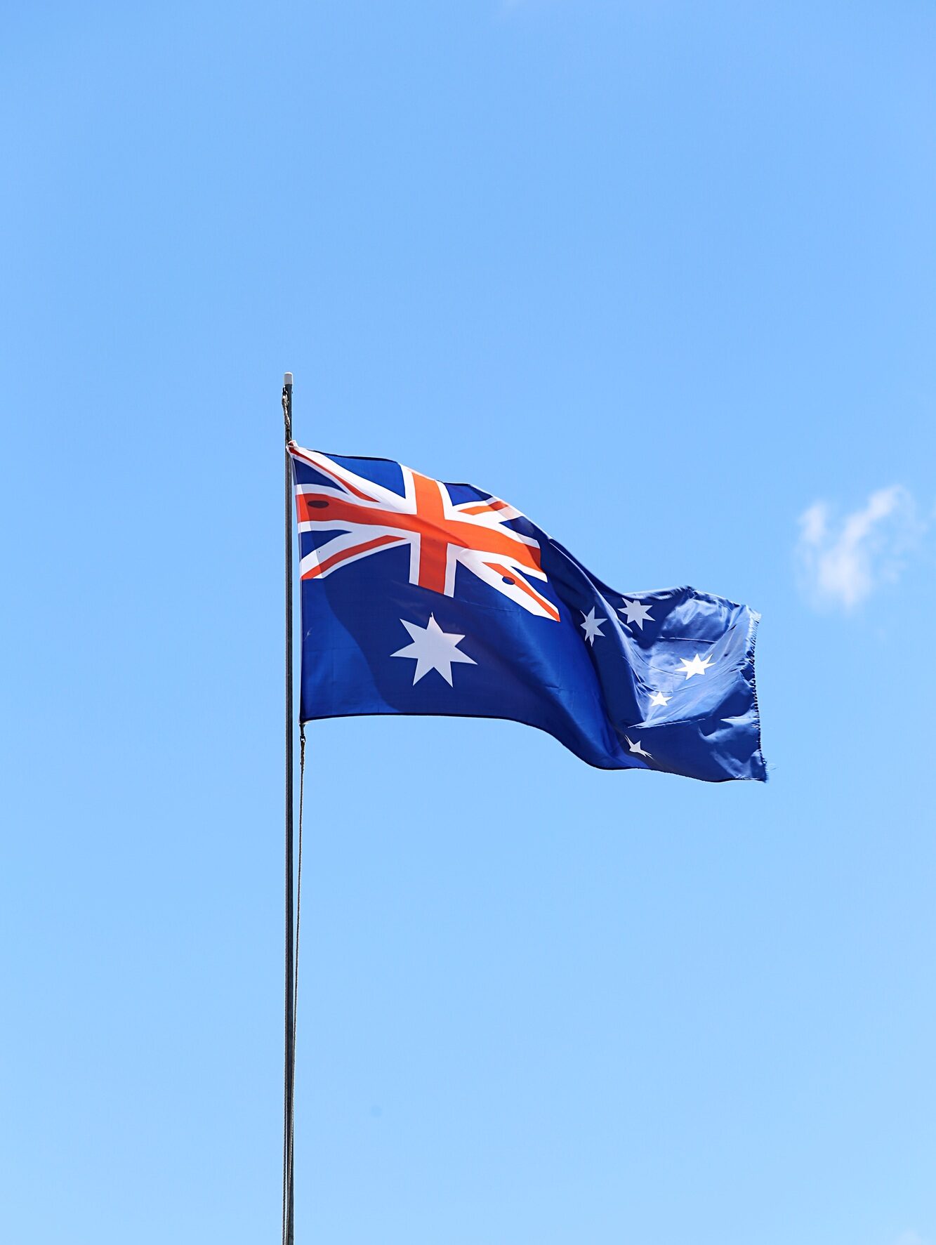 Australian flag flying on a flagpole.